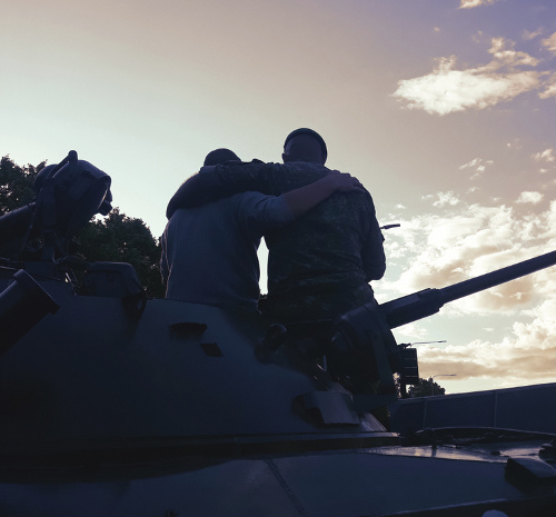 soldiers hugging on military tank